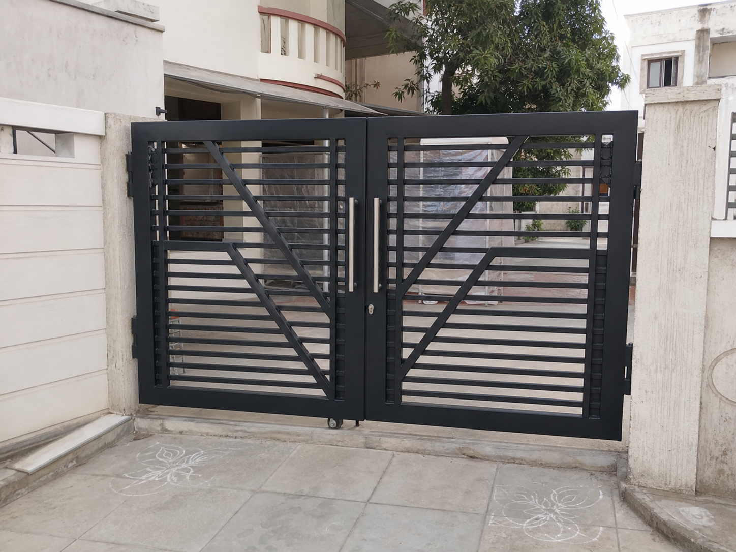 Realistic black steel main gate installed at a home entrance